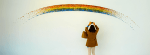 Emotionale Heilung eine Frau fotographiert einen Regenbogen, der sich langsam auflöst